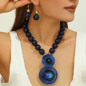 Handcrafted blue resin beaded necklace and earrings detail closeup showing elegant wire design.