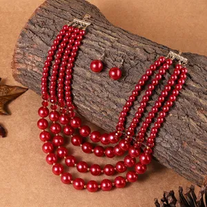 Ensemble de collier et boucles d'oreilles en fausses perles rouges pour mariage de femme.