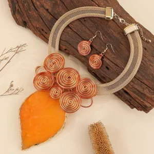 Handmade statement jewelry set featuring mesh choker necklace and orange resin leaf pendant.