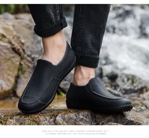 Outdoor waterproof short rain boots detail view, black slip-on rubber shoes for working.