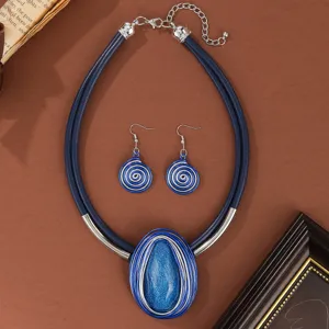 Blue leather cord resin gemstone necklace and earrings set, handmade wire design detail view.