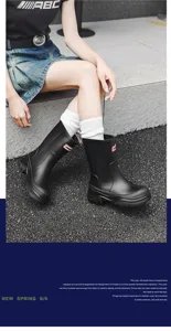 Stylish black mid-calf waterproof rain boots for women, ideal for rainy weather and outdoor activities.