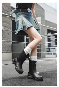 Women's mid-calf solid color waterproof rain boots, anti-slip slip-on design for rainy days outdoor.
