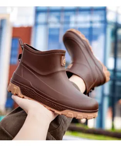 Close up view of brown waterproof rain boots with non slip thick sole for outdoor work and fishing.