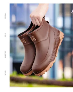 Detail view of men's waterproof short rain boots with anti-slip thick soles and side logo.