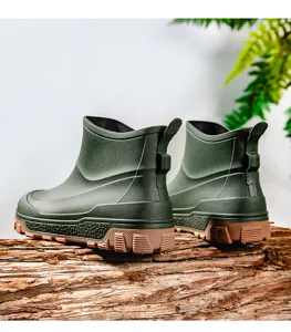 Men short waterproof rain boots detail shot, dark green outdoor non-slip rubber shoes.