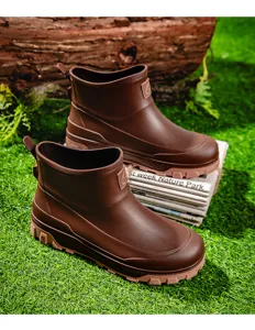 Detailed view of brown waterproof men's short rain boots showing textured anti-slip rubber sole.