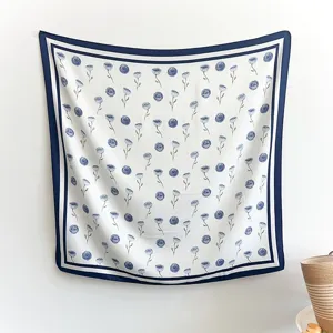 Detail view of Korean style blue floral imitation silk square scarf with elegant border.