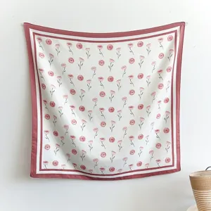 Close-up of elegant pink rose floral print square scarf detail, soft texture aesthetic hanging.