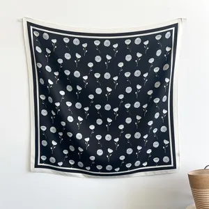 Close up view of black and white floral silk square scarf, elegant design for women daily wear.