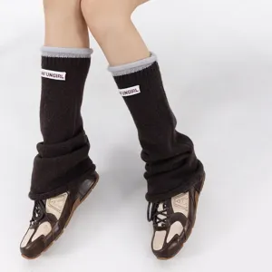 Women's brown knit leg warmers winter cozy stacked socks with contrast grey cuff and white label.