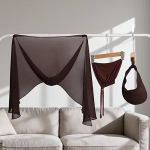Detailed view of the dark brown chiffon shawl, ribbon cap and empty-top visor set.