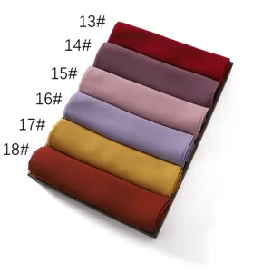 Chiffon scarf detail showing colorful rolled fabric variants in a neat display tray.