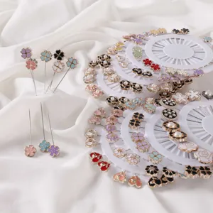 Detailed shot of floral brooch pins set on white round organizers for clothing and scarf styling.