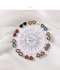 Colorful heart-shaped head pins detail, decorative stitching pins for tailoring and DIY crafts.