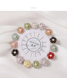 Detailed view of colorful camellia flower brooch pins, enamel floral pearl straight pins for apparel.