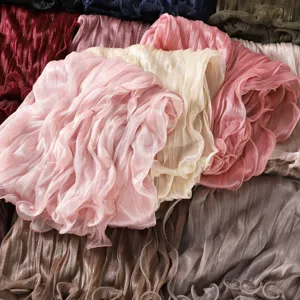 Detail view of lightweight crinkled silk gauze scarf with ruffle edge, various colors.