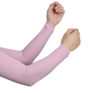Detail shot of pink sun protection arm sleeves showing elastic knitted fabric texture and arm fit.