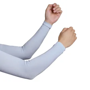 Close-up detail of light blue sun protection arm sleeves worn on arms for outdoor driving.
