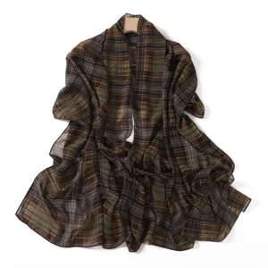 Detailed view of the lightweight brown plaid chiffon scarf shawl draped gracefully on hanger.