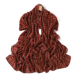Close-up detail of red plaid chiffon scarf texture, lightweight translucent fabric drapery.