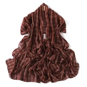 Detailed view of red-brown plaid chiffon scarf, showcasing soft lightweight fabric texture.