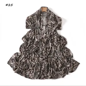 Detailed view of long animal print scarf featuring soft mercerized cotton fabric.