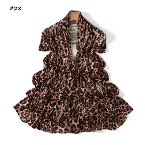 Leopard print scarf detail shot, elegant fabric texture, versatile fashion accessory.