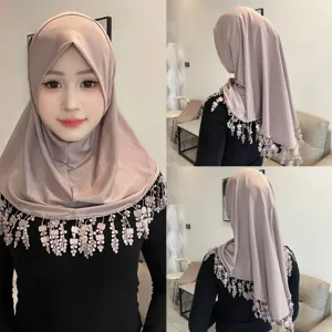 Detailed view of the crystal linen hijab featuring elegant lace tassel fringe and soft brim design.