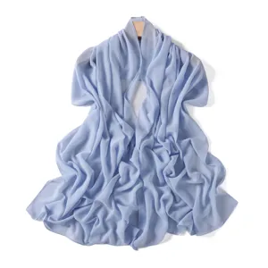 Detail shot of lightweight light blue chiffon scarf, soft fabric drape and smooth texture.