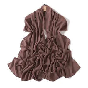 Detail view of a plain brown chiffon long scarf, showing soft draped texture and lightweight fabric.