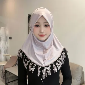 Detail view of the elegant crystal linen hijab with delicate lace tassel trim and soft brim.