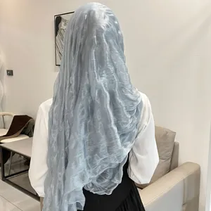 Detailed view of the shimmering light blue wrinkle hijab scarf, showing soft fabric texture.