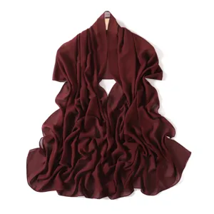 Exquisite detail of lightweight burgundy chiffon long scarf, showing soft texture and fluid drape.