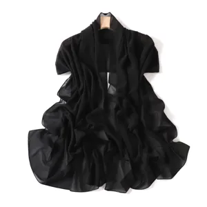 Black sheer chiffon scarf shawl draped on wooden hanger showing texture and drape.