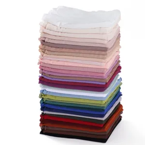 Detailed view of stacked colorful elastic mesh scarves, lightweight and breathable fabric.