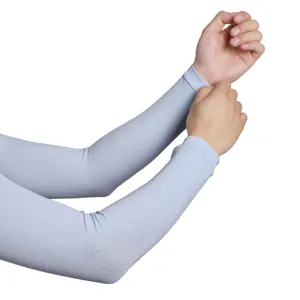 Close-up detail showing breathable light blue sun protection arm sleeves worn on arms.