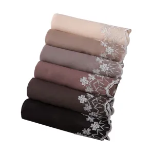 Detailed view of luxury floral embroidered shiny pearl hijab scarves stack in gradient neutral colors.