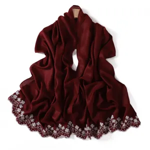 Burgundy scarf with delicate white floral embroidery and a shimmering finish for elegant styling.