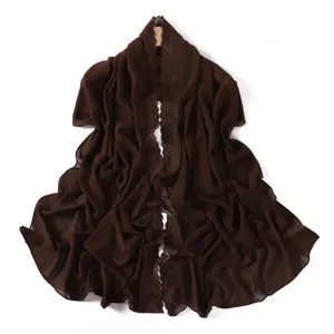 Detailed close-up view of the dark brown chiffon shawl featuring delicate floral embroidery edge.