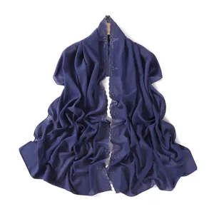 Close-up of elegant floral embroidered chiffon scarf with delicate edge details and smooth drape.