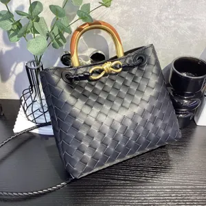 Black leather woven handbag with wooden metal top handle fashionable tote shoulder crossbody bag.