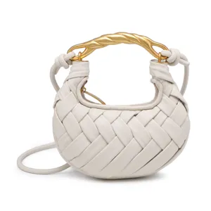 Mini white woven leather crossbody bag featuring a luxury gold twisted metal handle.