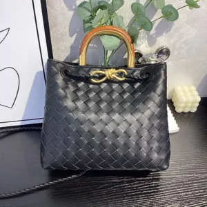 Black woven leather handbag with wooden metal handle and gold knot hardware fashion tote bag.