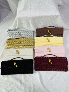 Detailed view showcasing multiple woven clutch handbags in assorted colors with metal knot latches.