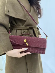 Chic woven shoulder bag for women, retro long baguette clutch with stylish knot clasp design.
