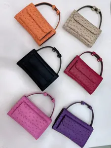 Detail view of colorful ostrich pattern baguette underarm bags showing various fashion colors.
