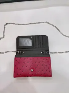 Ostrich pattern crossbody bag detail showing card slots, ID window, and metallic chain strap.