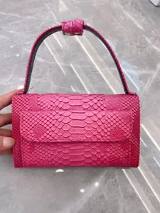 Pink snake texture flap shoulder bag for women, stylish underarm handbag with handle.