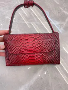 Red exotic leather texture underarm shoulder bag for women, stylish flap design with handle.
